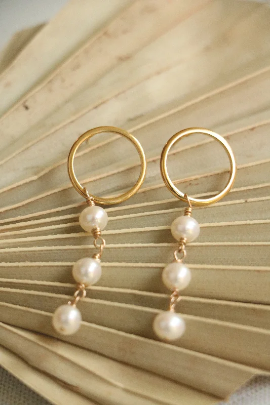 Hoop earrings with open designs for a modern, lighthearted vibe-revolve pearl studs { gold }